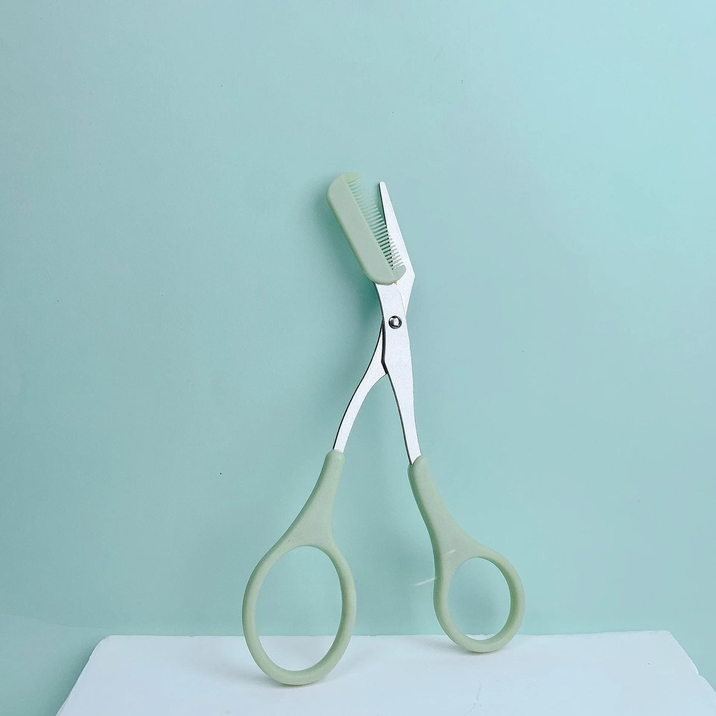 Pink eyebrow trimming scissors with built-in comb - stainless steel, precise grooming tool, creating perfect eyebrows